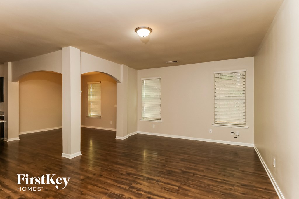 the living room of an empty house with a hard wood floor