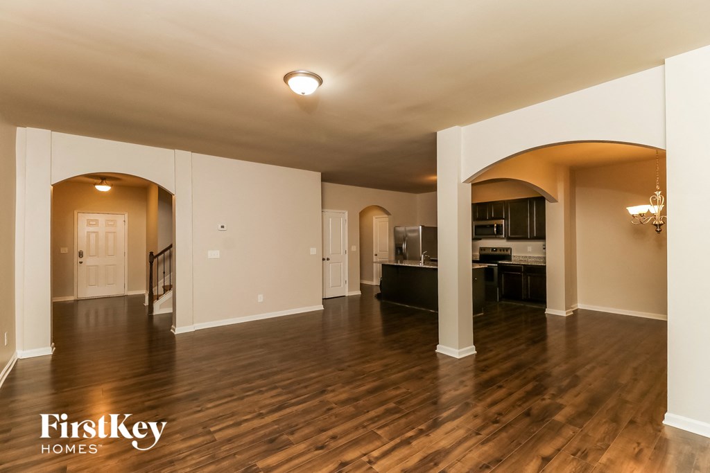 the living room and dining room of an open floor plan