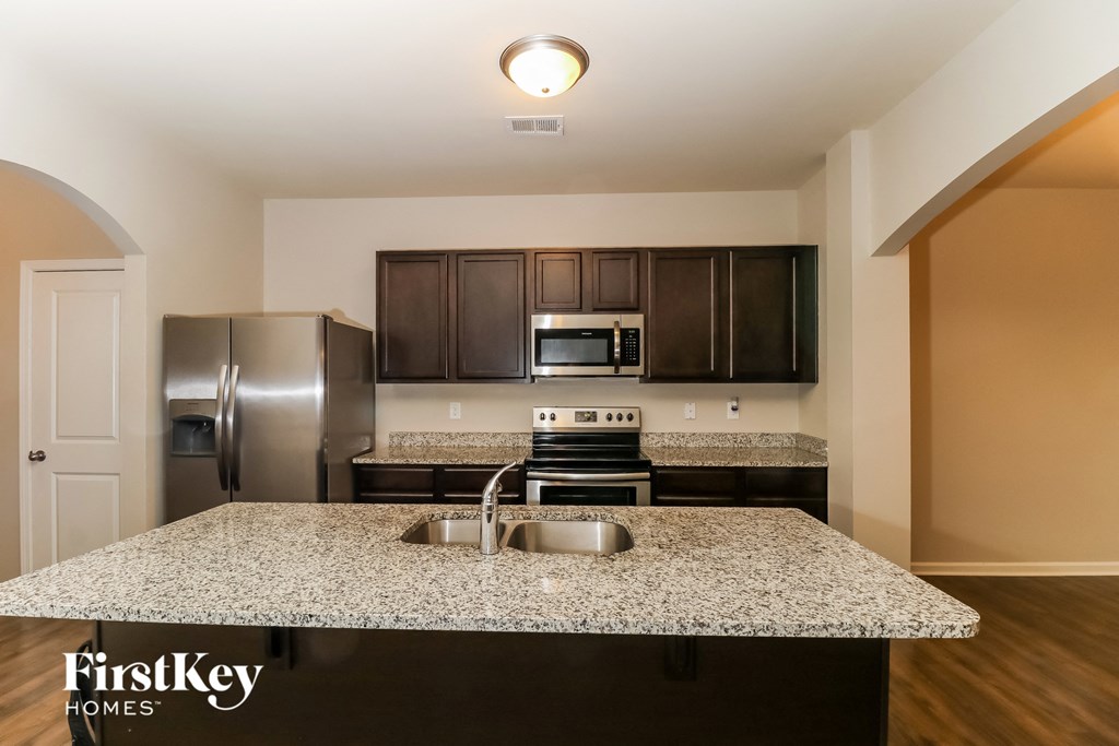 a kitchen with granite countertops and stainless steel appliances