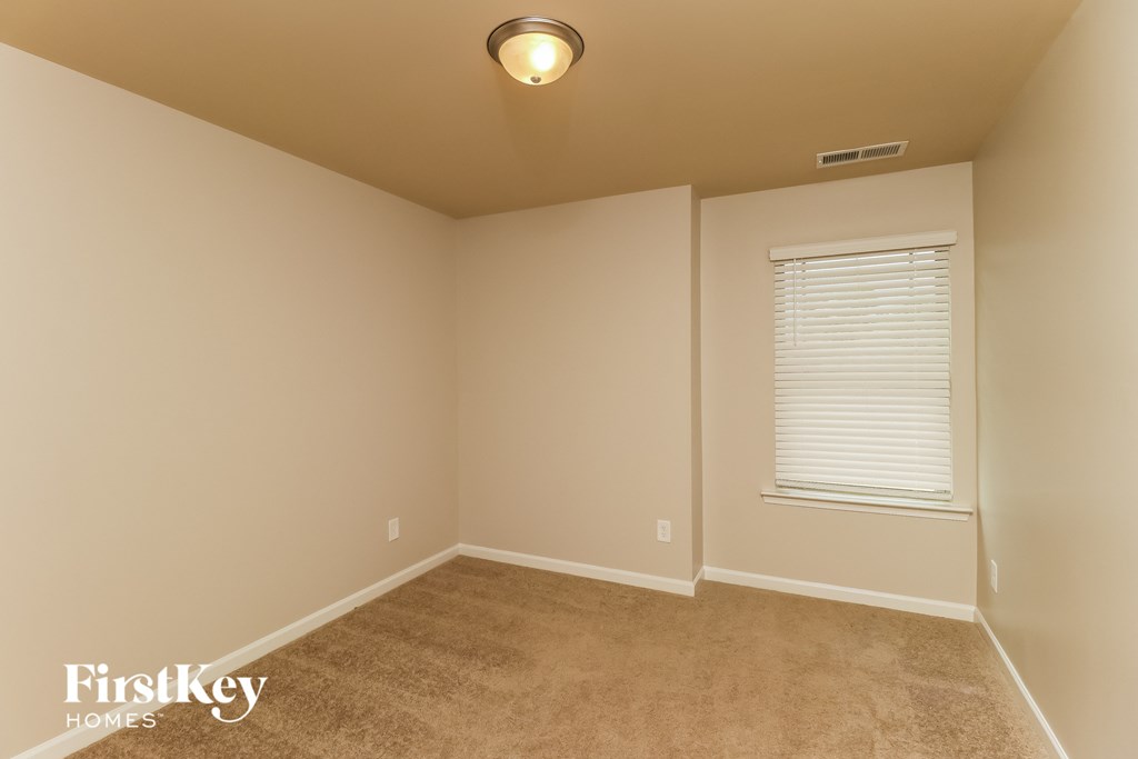 the upstairs bedroom has been cleaned and staged with carpet and a window