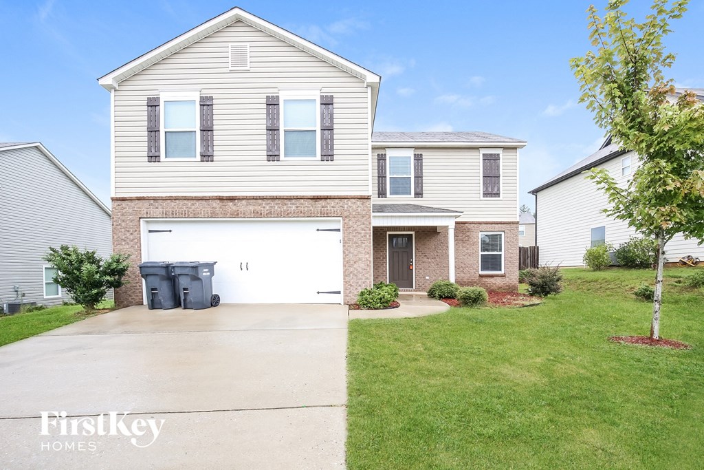 a white house with a driveway and a white garage door