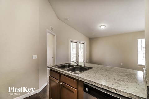 A kitchen with a sink and a window.