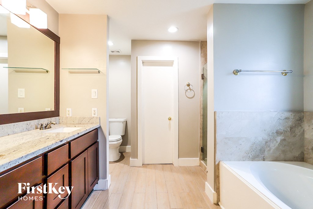 a bathroom with a tub and a sink and a toilet