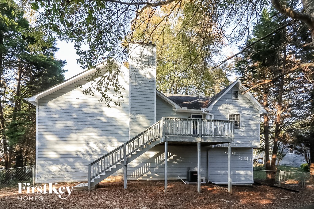 a blue house with a deck on the side of it