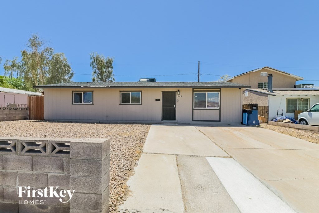 A house with a driveway in front of it and a sign that says FirstKey Homes.