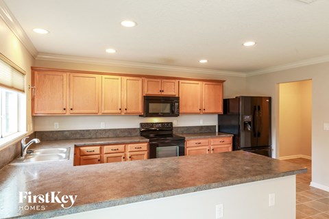 a kitchen with wooden cabinets and a granite counter top