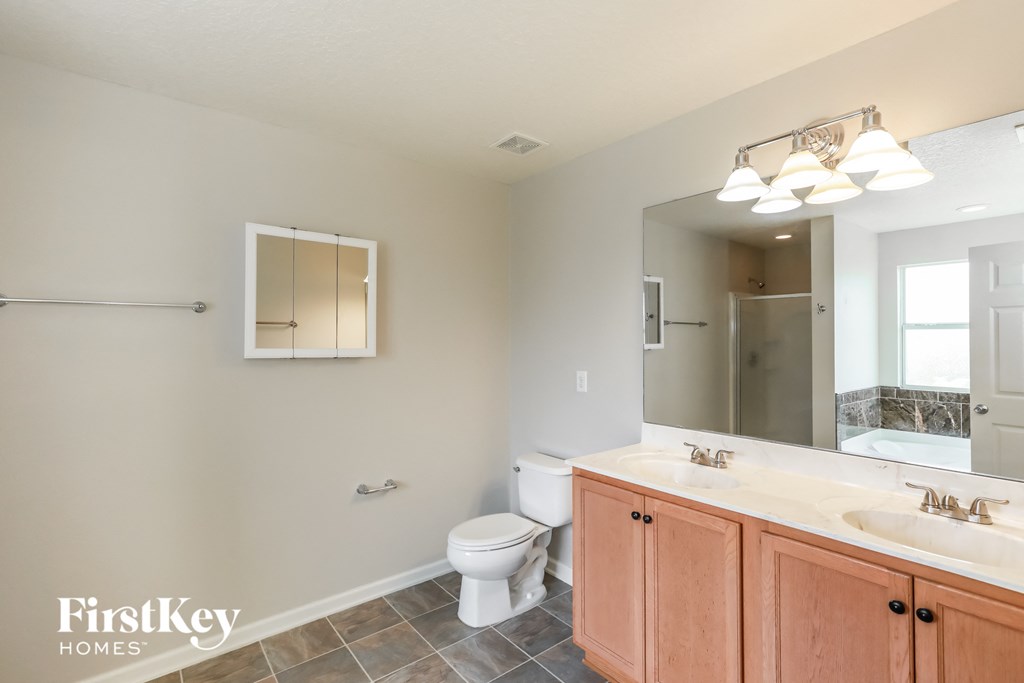 a bathroom with a toilet and a sink and a mirror