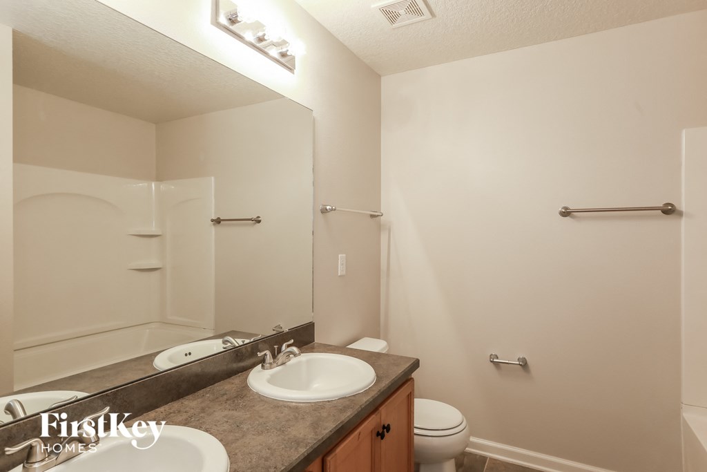 a bathroom with a sink and a toilet and a mirror