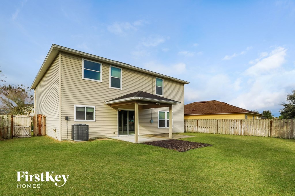 a house with a lawn and a fence