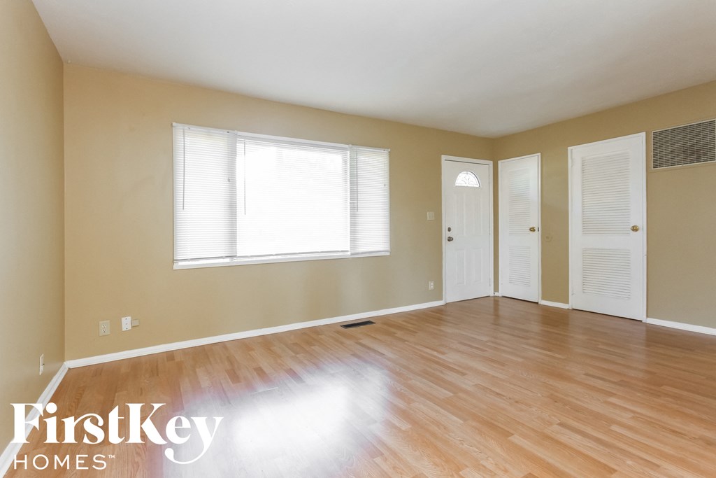A room with wooden floors and white walls.