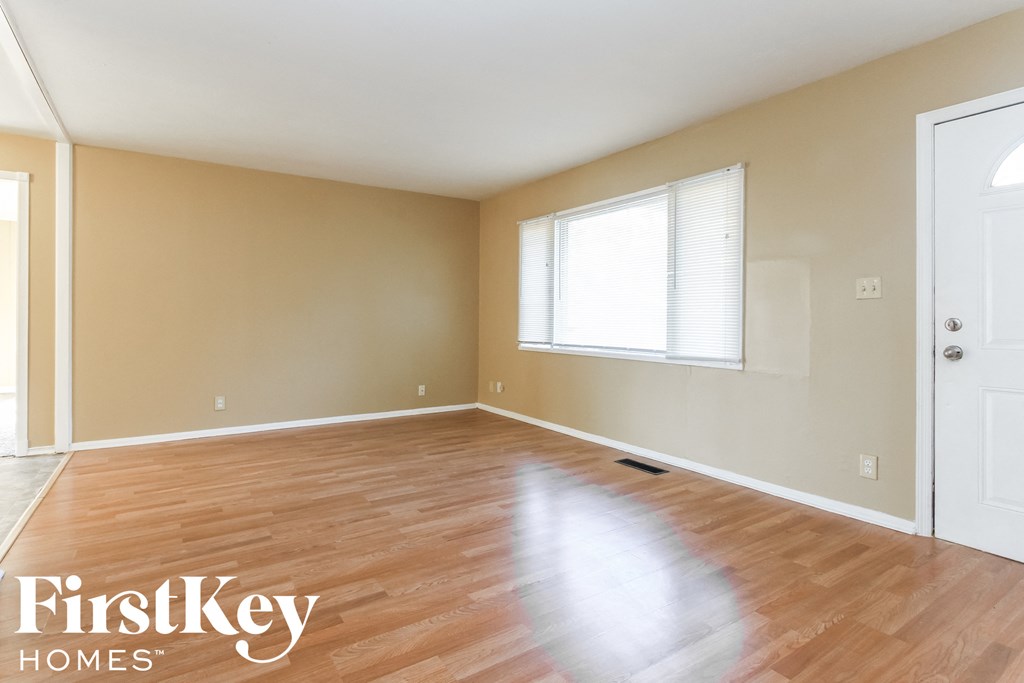 A room with wooden floors and a white door.