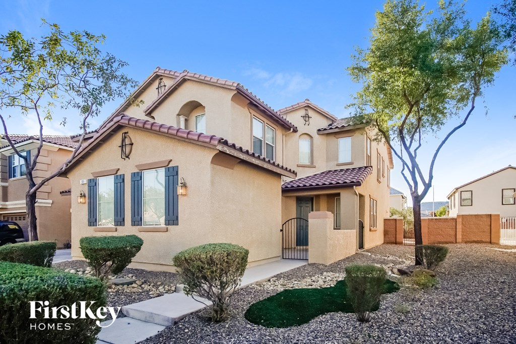 a house with a driveway and a yard in front of it