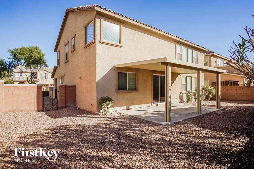 a house with a covered porch and a gravel driveway