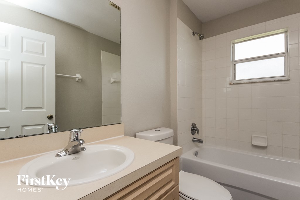 a bathroom with a sink and a toilet and a tub