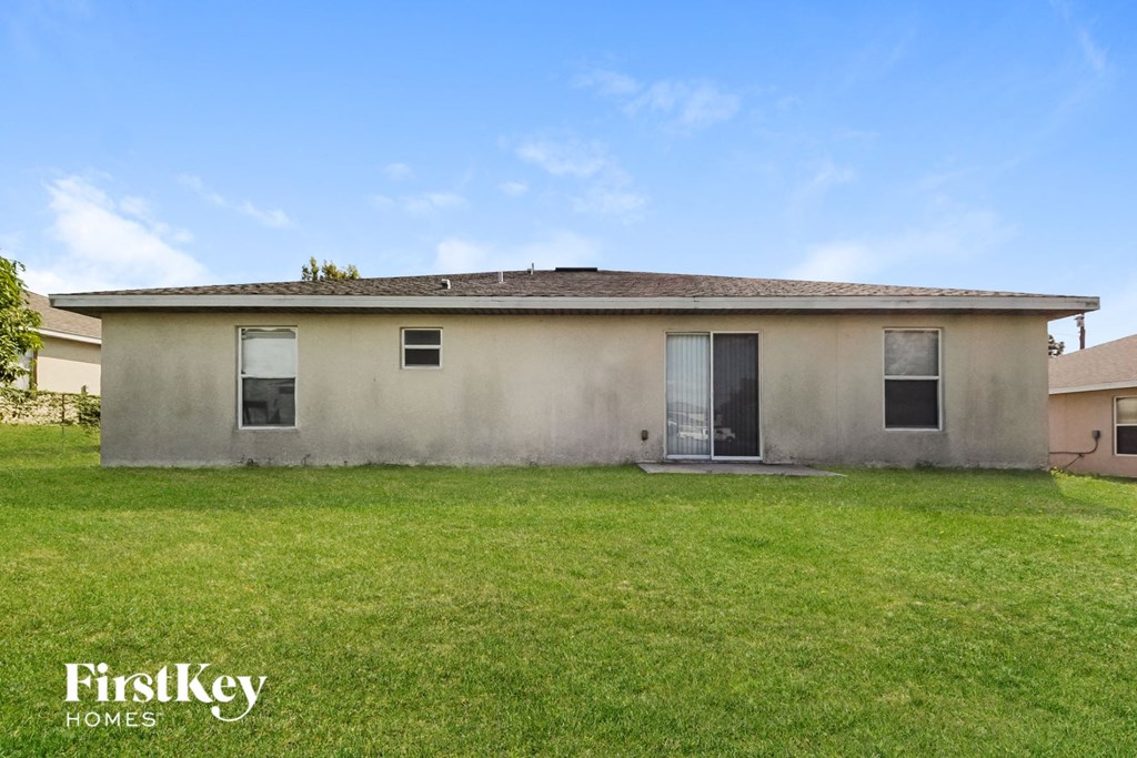 an old house with a grass yard in front of it