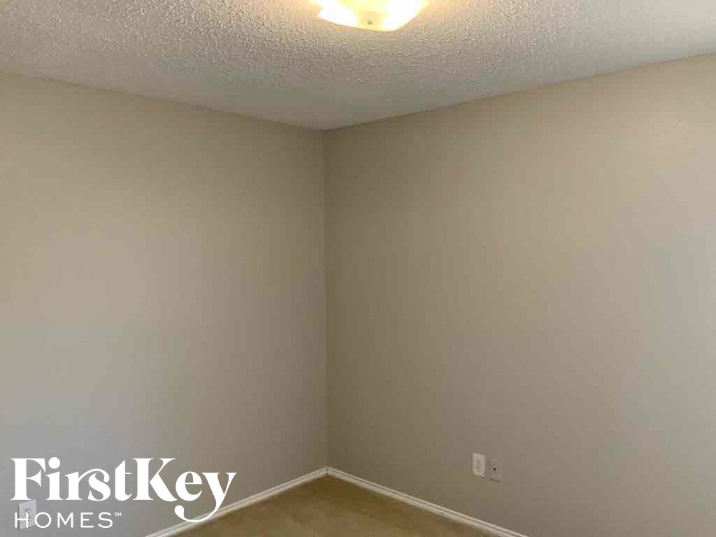 a room with white walls and a light on the ceiling