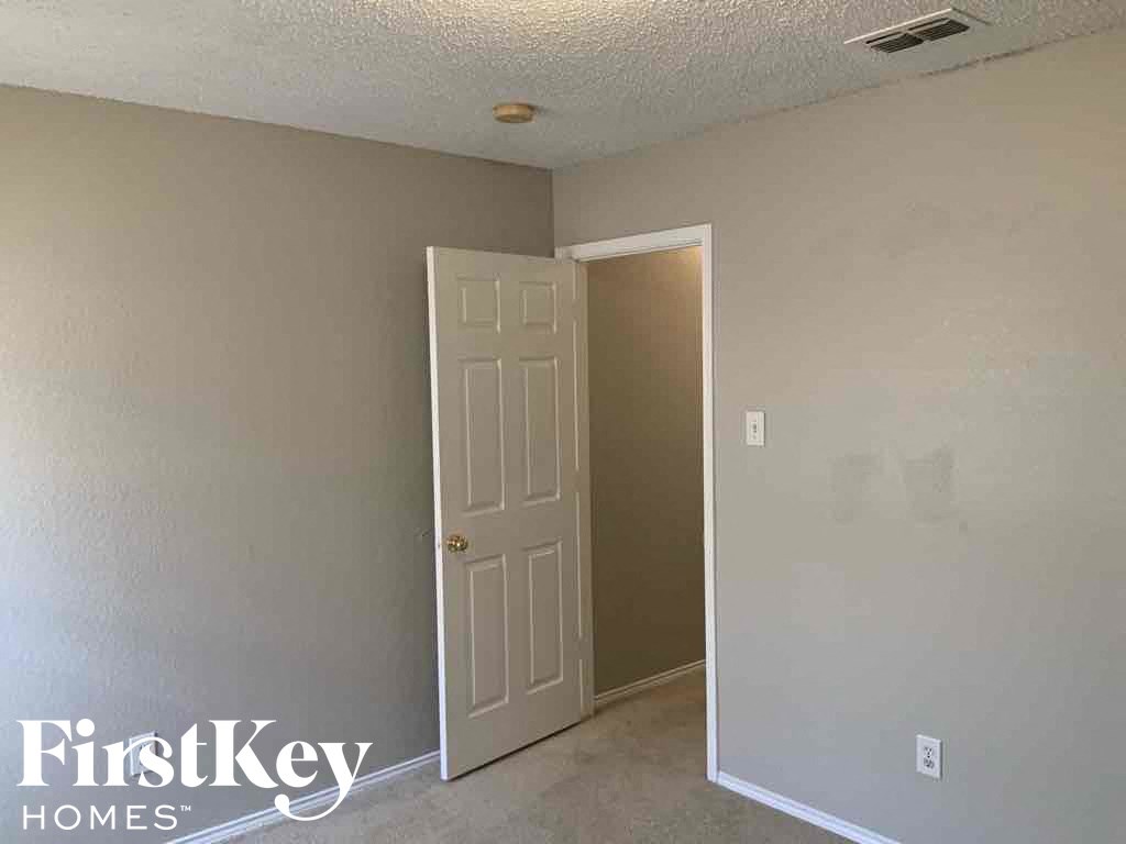 a bedroom with a white door and a closet