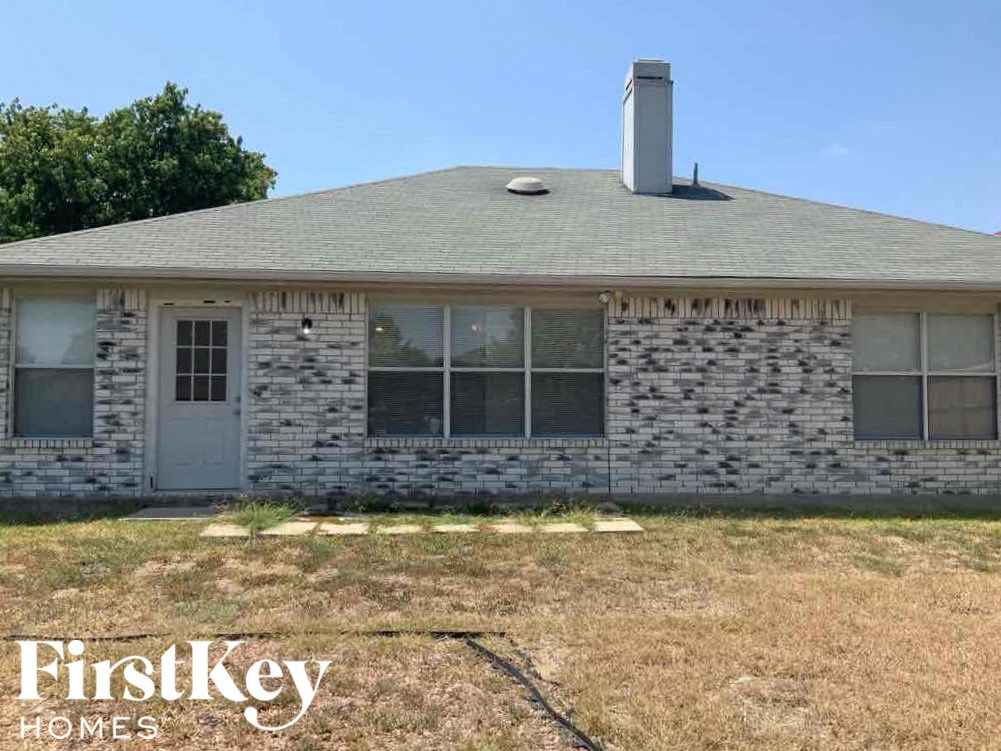 a brick house with a chimney on top of it