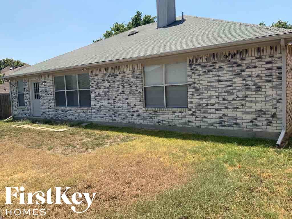 a brick house with a yard in front of it