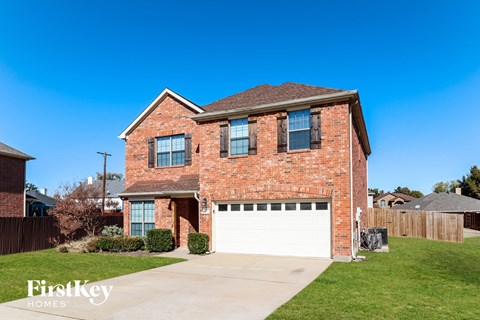 a brick house with a white garage door