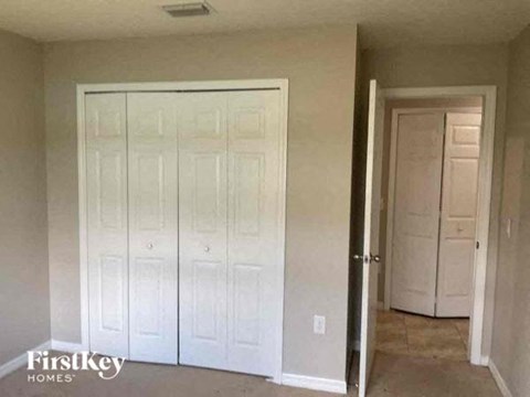 an empty room with white closets and a door