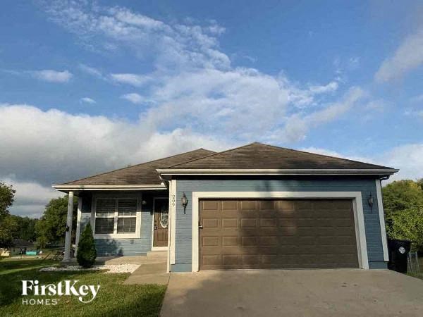 a small blue house with a garage door