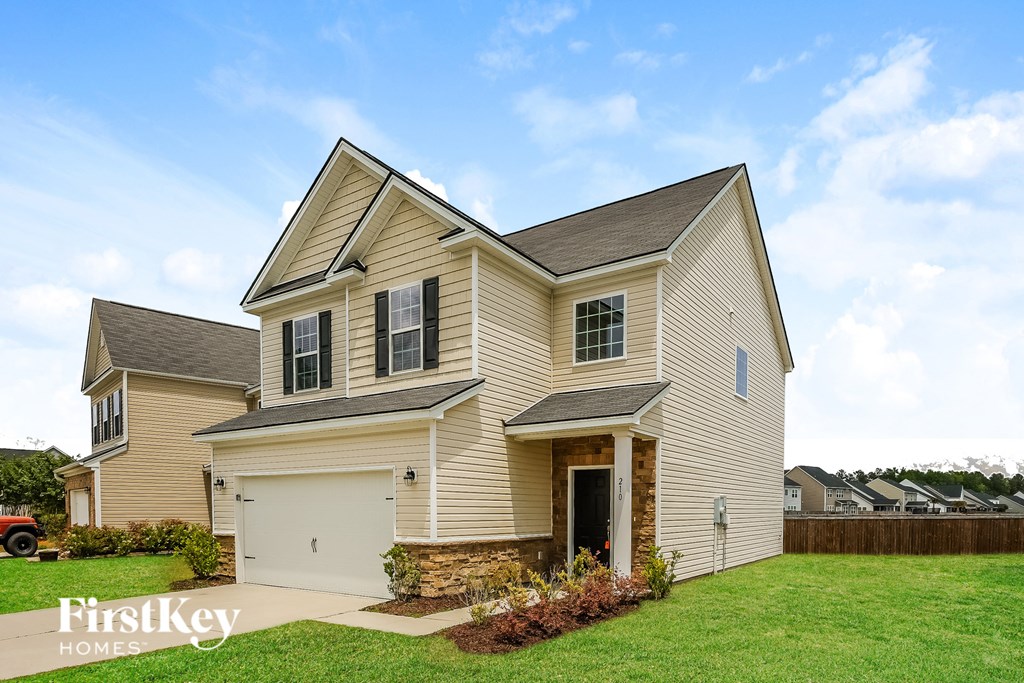 A two-story house with a garage is for sale by FirstKey Homes.
