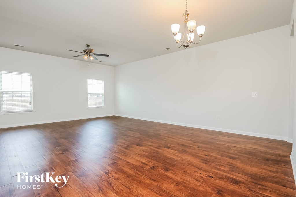 A room with wooden floors and a ceiling fan.