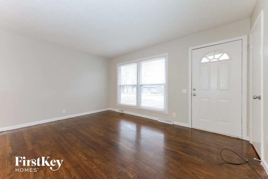 A room with wooden floors and a white door.