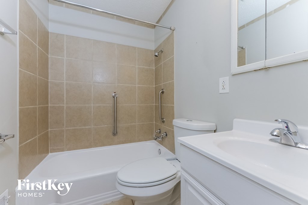 A bathroom with a white toilet and sink.