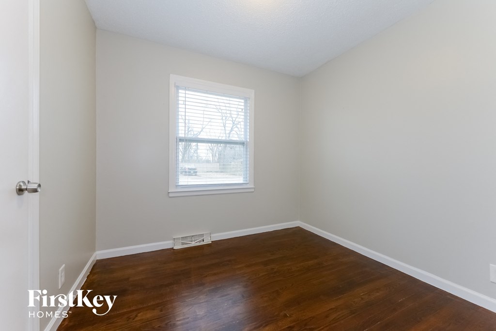 A room with a wooden floor and a window.