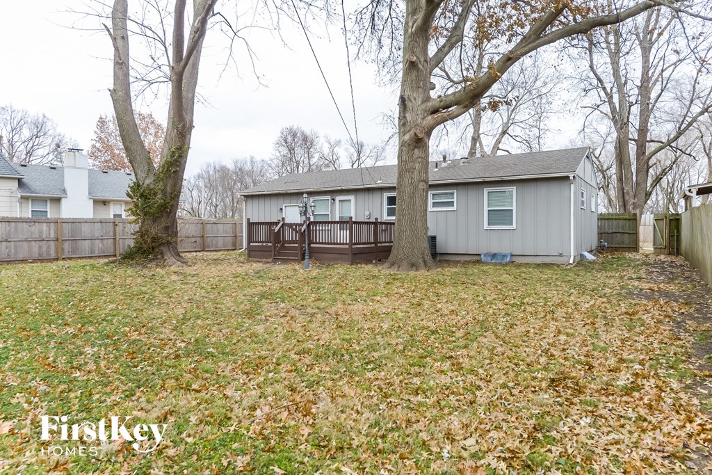 A backyard with a shed and a fence.