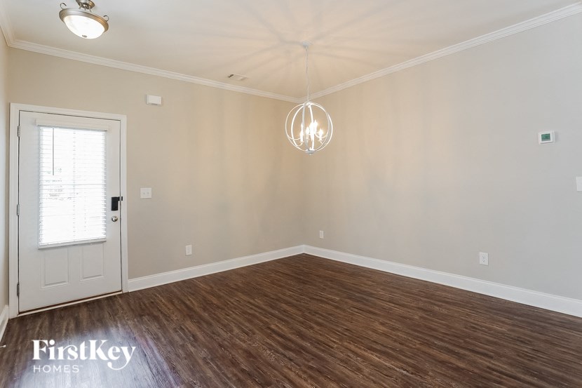 A room with wooden floors and a white door.