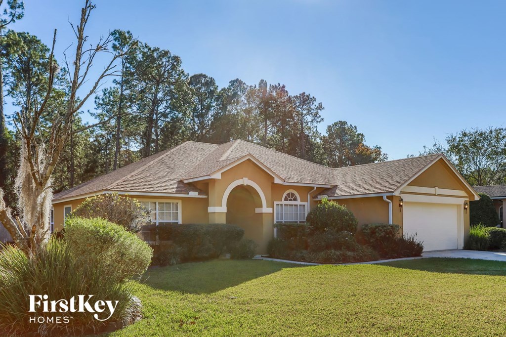 a home with a lawn and a garage