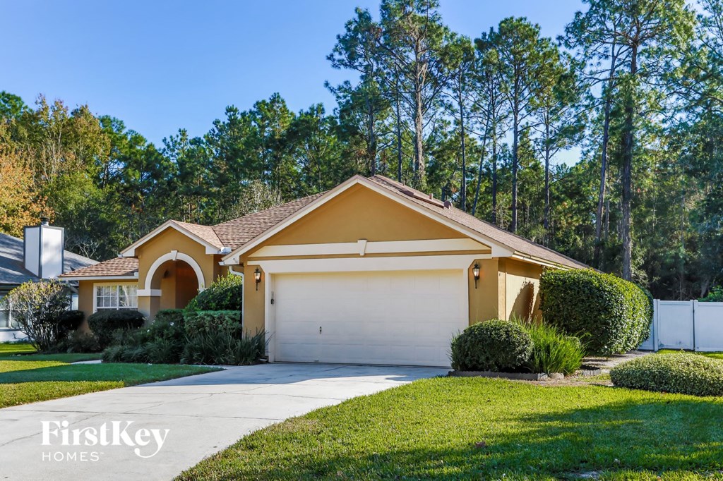 a yellow house with a white garage door