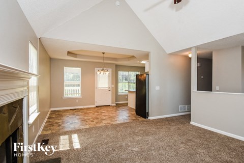 the living room of an empty house with a fireplace