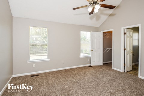 the master bedroom has a closet and a ceiling fan