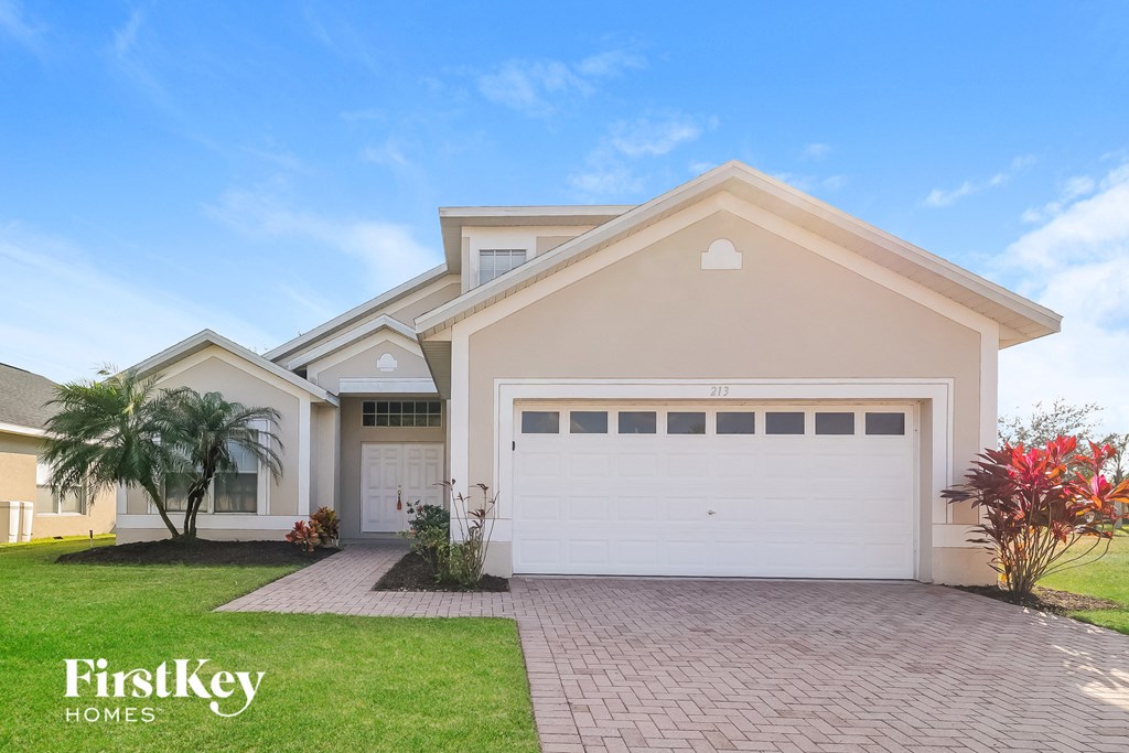 a house with a white garage door and a lawn