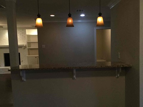 A kitchen area with a counter and a wall.