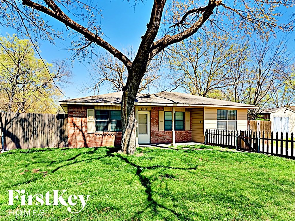 A house with a tree in front of it.