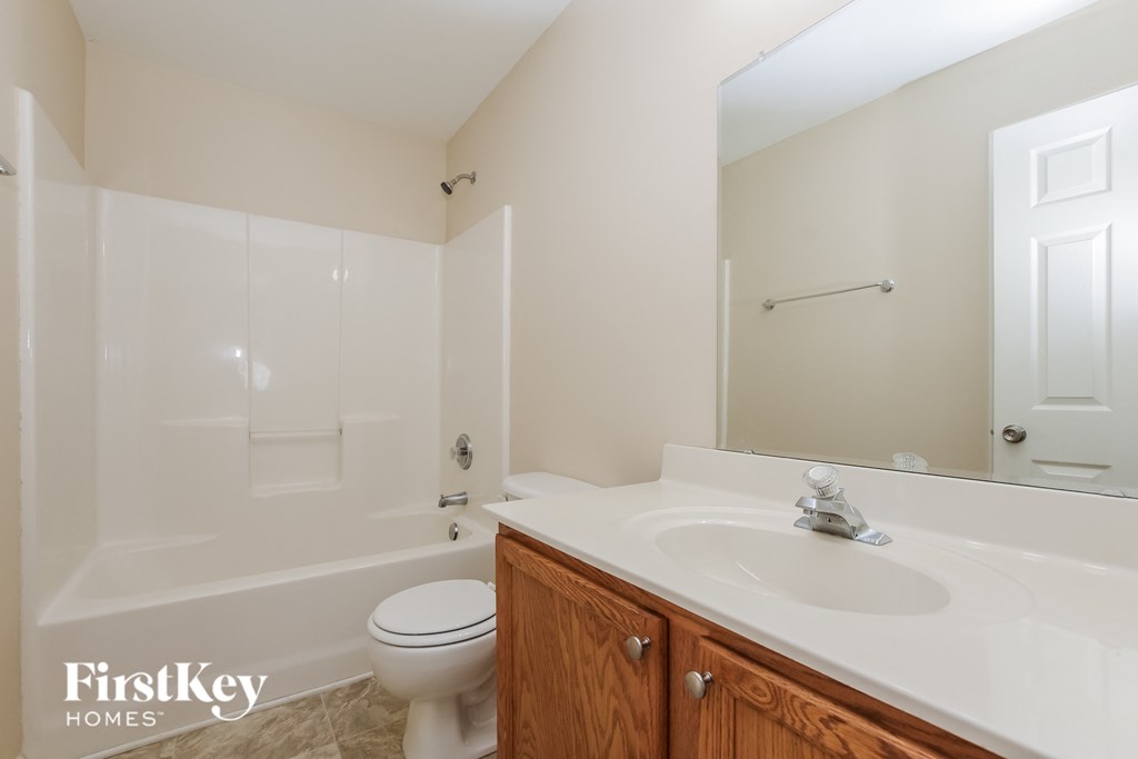 a bathroom with a sink and a toilet and a shower