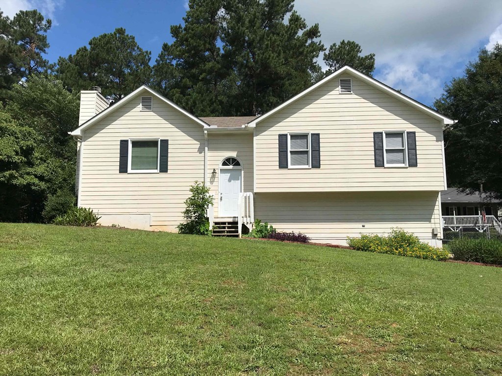 a white house with a lawn in front of it
