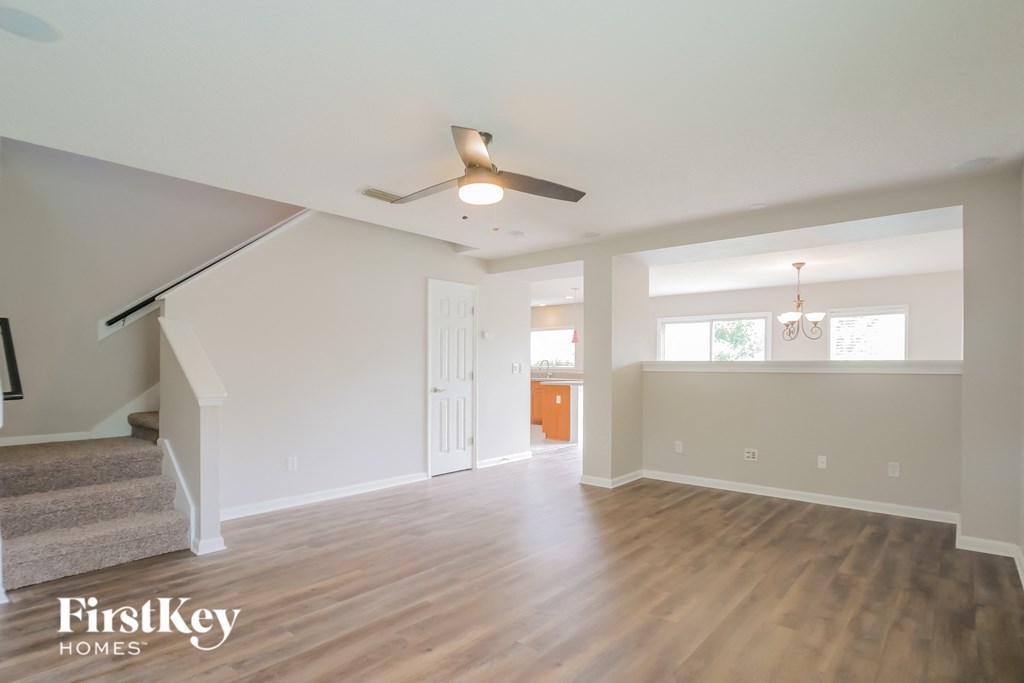 a living room with a ceiling fan and wood floors