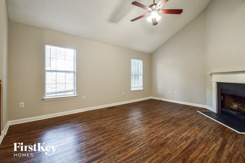 the living room with wood flooring and a fireplace