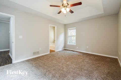 the master bedroom is spacious and has a ceiling fan