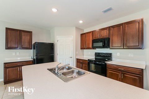 A kitchen with brown cabinets and a white counter top.