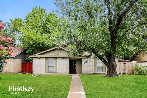 A house with a tree in front of it.