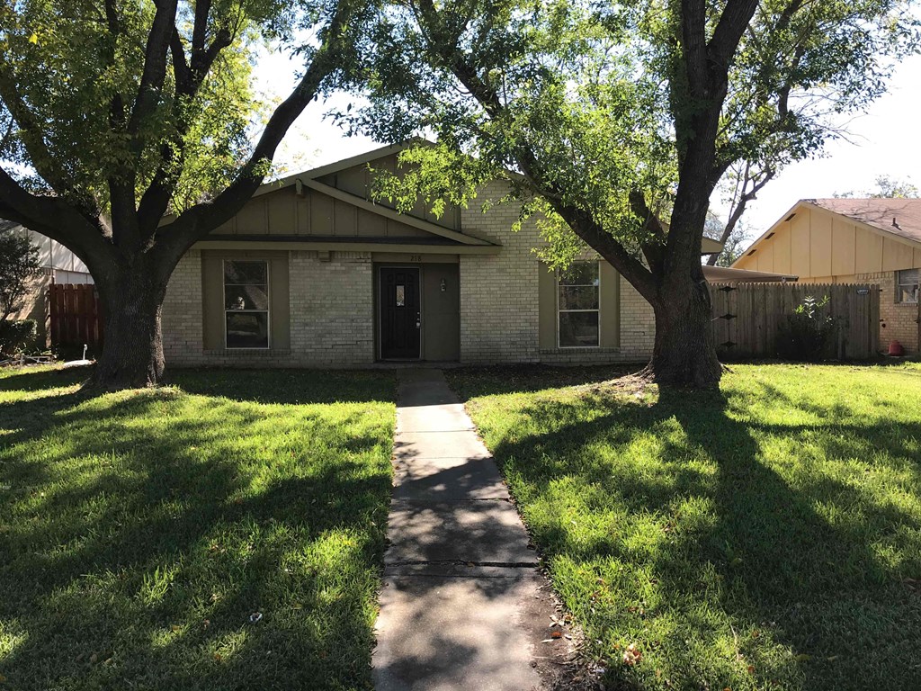 A house with a tree in front of it.