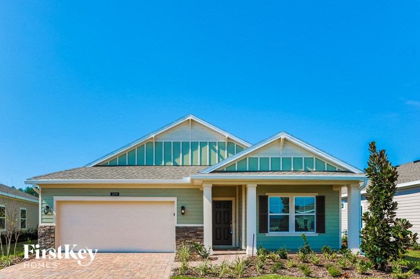 a house with a garage door and a roof