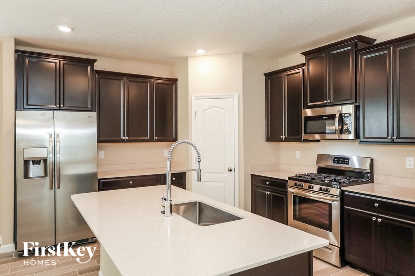 a kitchen with stainless steel appliances and a white counter top